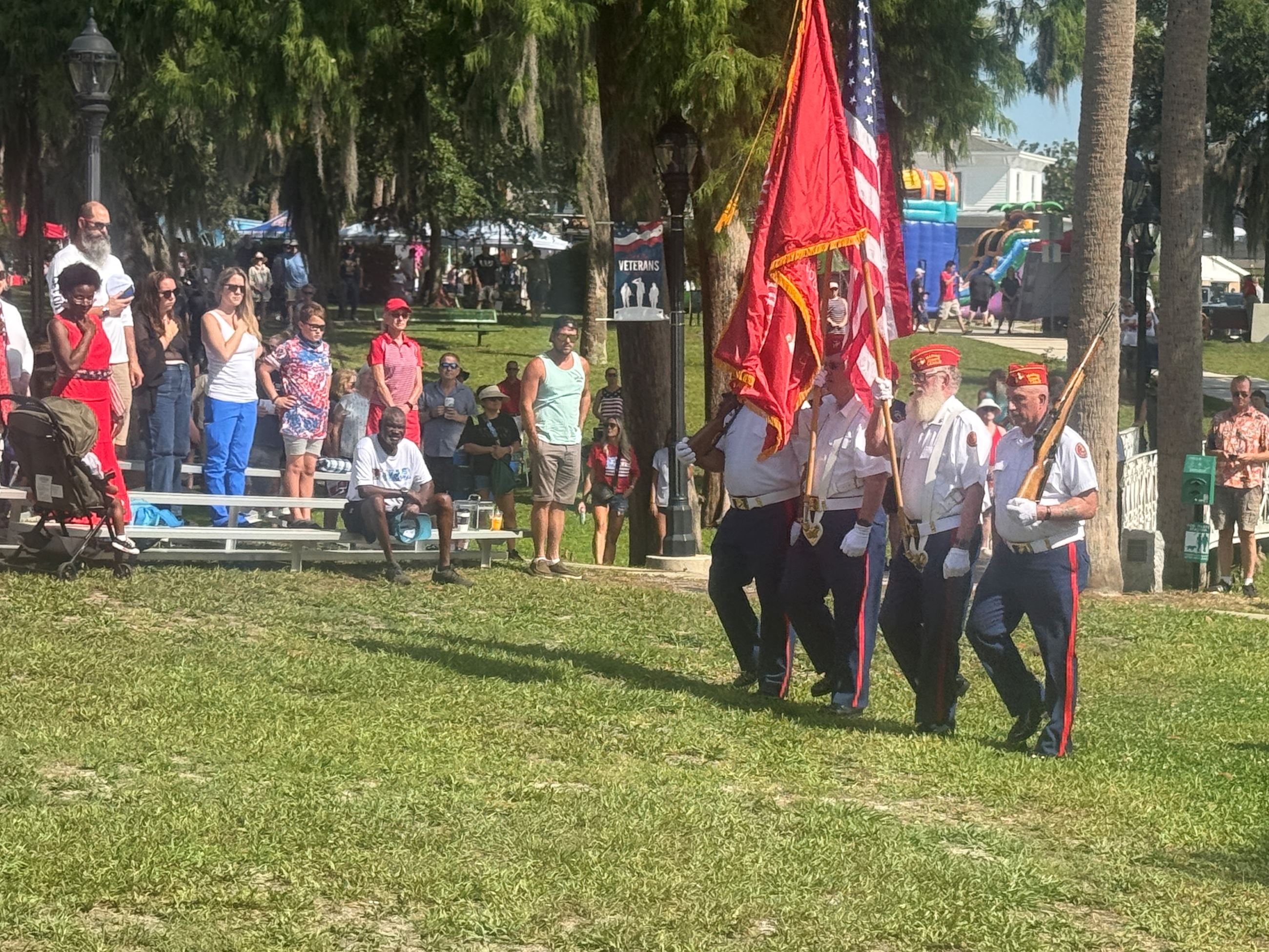 Veterans marching with flags during Presentation of Colors at Riverfest